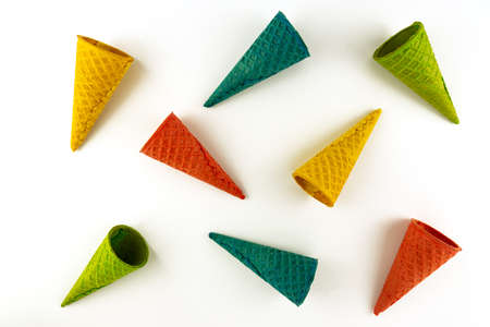 Set of various bright multicolored ice-cream waffle cones on white background