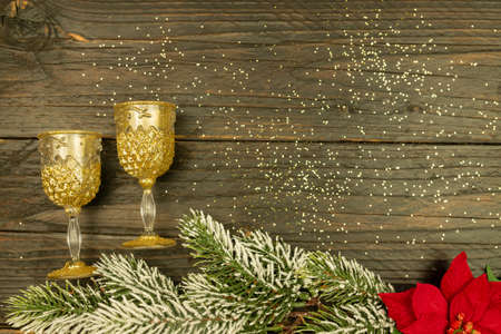 Happy New year 2021 celebration. Champagne glasses and poinsettia on wooden background. Flat layの写真素材