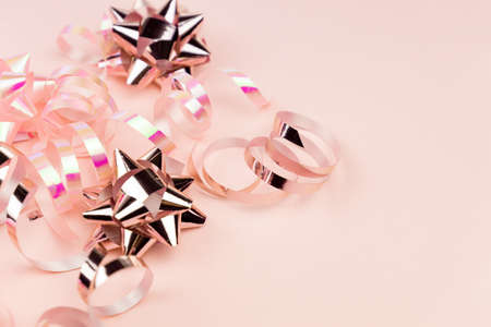 Christmas Holidays Background in pink color. Winter holidays, New Year. Flat lay, top view, copy space. Pink Streamers With Sparkling Glitterの写真素材