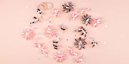 Christmas Holidays Background in pink color. Winter holidays, New Year. Flat lay, top view, copy space. Pink Streamers With Sparkling Glitter.の写真素材