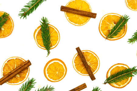 Composition of cinnamon, fur tree branches and dried oranges on white background. Flat lay, top...