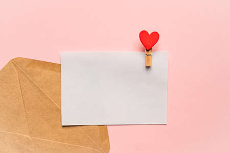 Love letter mockup. Greeting card with pin and red heart with copy space for text or design. Festive...