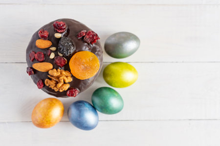 Easter cake and colored eggs on white background. Holiday food and easter concept.の写真素材