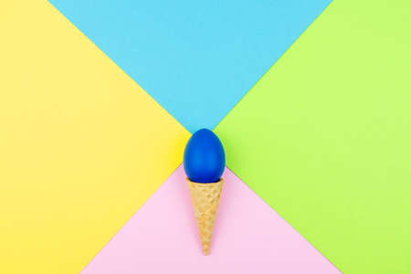 Pop colors. Festive multicolored background with bright sugar sprinkles scattered on paper, wafer cone end easter eggの写真素材