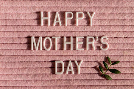 Happy Mother's Day letter board and green leaves. Mother's Day greting card