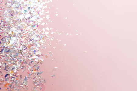 neon pearl foil confetti on light pink background. Festive, party or holiday glowing backdrop. Flat lay, top viewの写真素材