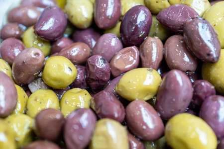 green olives stuffed with paprika. food background.の写真素材