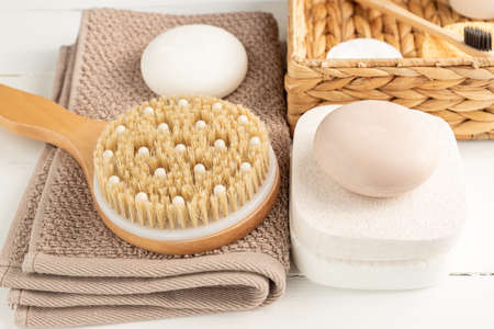 Spa, beauty cosmetics and body care treatment concept. Creative composition with bath accessories - massaging brush, soap bars and sponges on white background.の写真素材