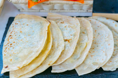 vegan gourmet flat bread kutabs with herbs and cheese on street food market