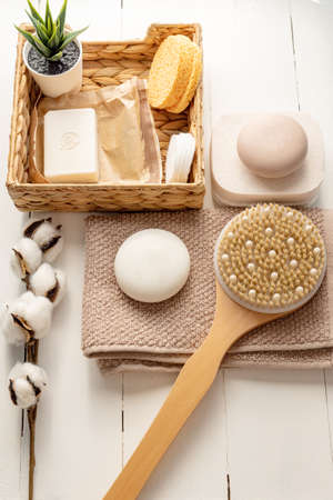 Flat lay composition with bath and skin care accessories on white background.