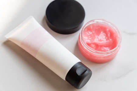 Face care and beauty concept. Cream, scrub, lotion on marble background. Organic cosmetics for...