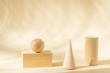 Stands for product of wooden natural shapes. Cube, ball and cone as podiums. Creative composition on beige backgroundの写真素材