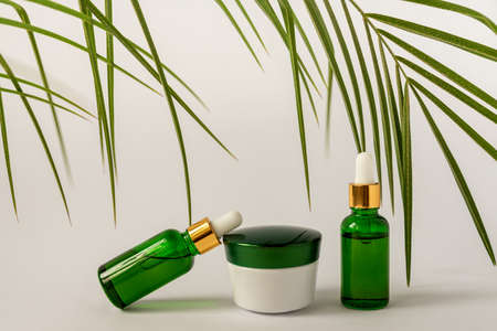 Moisturizer cream jar, serum in glass bottle on white background with copu space. Set for skin and body care beauty products. unbranded package.の写真素材