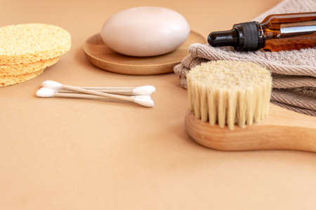 composition with bathroom accesories and natural cosmetic on white beige background with copy space.