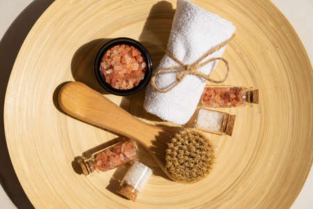 Natural cosmetics set in eco-friendly packaging in bamboo plate with cotton towel and sea salt. SPA, bath beauty productsの写真素材