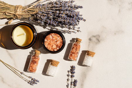 dry lavender flowers and lavender aromatic sea salt with candle - natural skin care spaの写真素材