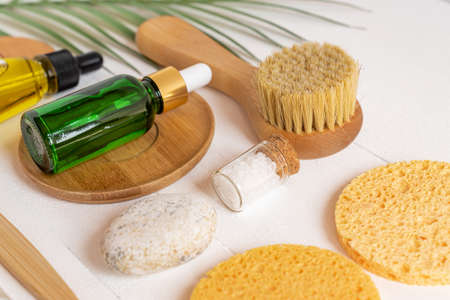 Face care accessories and cosmetics on wooden table. Spa treatment background. Zero waste concept....