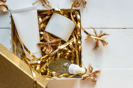 Beauty box set, bottles of natural cosmetics. Blogger skincare, face, hair and body essentials, salon treatments. Unbranded white tube and cream jar. Overhead, minimalism package, branding mockup.の写真素材