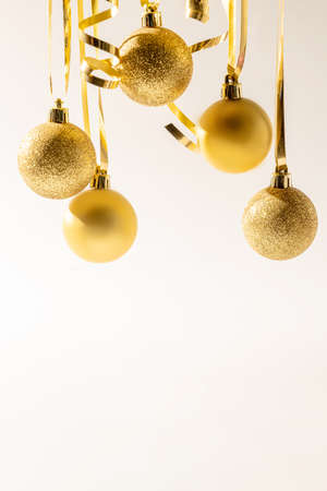 Christmas golden sparkling balls on white background. Christmas concept with copy space.の写真素材
