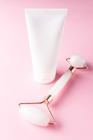 Pink Jade face roller and and face balm in unbranded tube for beauty facial massage therapy, Items for home treatment with Skin Care Anti-Aging Toolsの写真素材