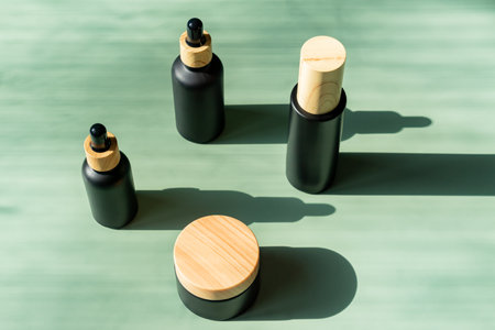 Fece serum in dropper bottle, essential oil, essence or lotion and face cream jar collection. beauty cosmetic skincare packaging design on green background with trendy hard shadows.の写真素材