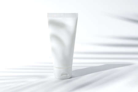 beauty skincare cosmetic mockup cream or lotion in bottle pakage on white background, sunscreen protection with summer coconut palm leaf tree shadow.の写真素材