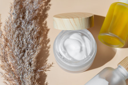 Moisturizing cream in eco-friendly bamboo jar and face beauty oil in dropper bottle. Natural organic...
