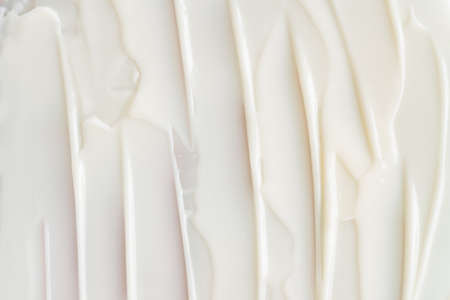 White smear and texture made by face cream white background. copyspace.