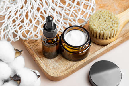 Set of unbranded skin care cosmetics with wooden face brush with natural bristle. minimalist style....