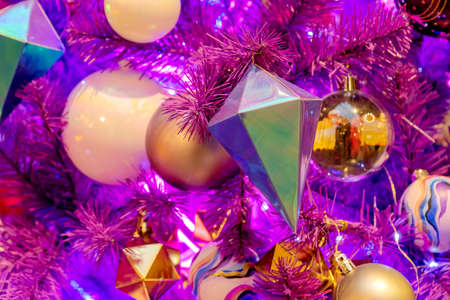 Festive neon background with christmas tree with toys and light garland. winter holidays conceptの写真素材