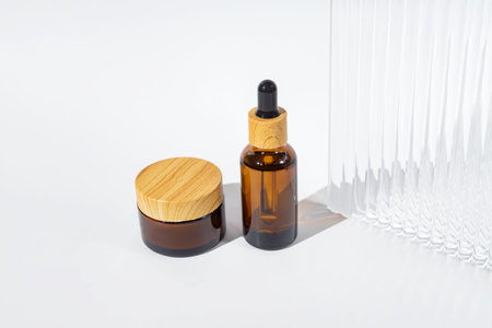 jar of organic cream with essential oil dropper bottle on white background. Natural organic product, beauty and spa conceptの写真素材