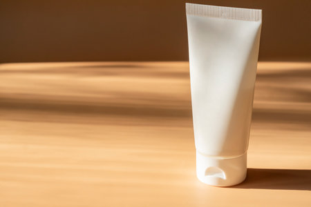 White cosmetic cream tube, balm jar mockup on beige background. Make up product blank container. body and face care.の写真素材