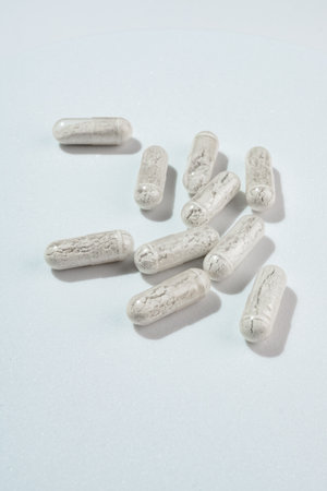 Organic food supplements, various minerals and vitamins scattered on white background.の写真素材