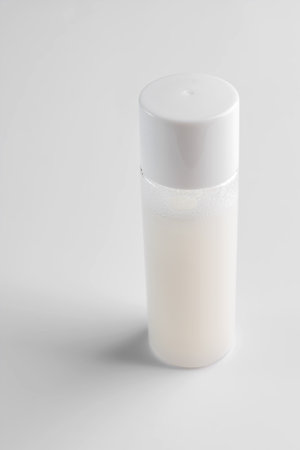 Transparent cosmetic bottle on white background. Healthy modern skin care beauty products. Mockup package of toner or lotion for healty skin. Cleanser or micellar waterの写真素材