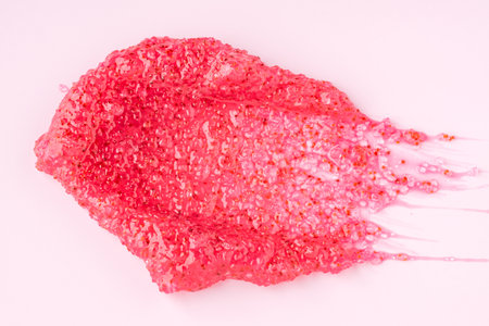 Strawberry scrub swatch on pink background. Body and skincare product for home spa treatment