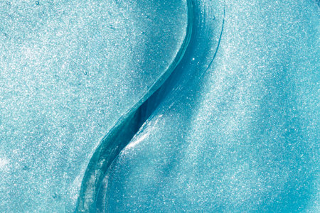 Shiny blue under eye patches as background, closeup. Cosmetic product.