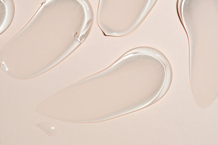 texture gel serum strokes on beige background.