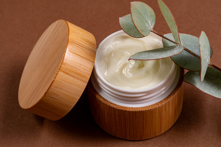 Face or body cream in bamboo jar with natural eucalyptus extracts and oils. Skin care cosmetics. Herbal treatmentの写真素材
