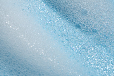 Soap cleanser foam texture. soft shampoo bubbles on blue background. Cosmetic foamy cleansing product swatchの写真素材