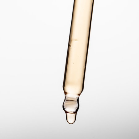 Pipette with serum, gel, oil or other cosmetic product on white background.の写真素材