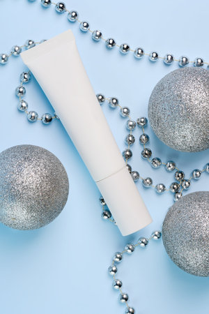 new year and Christmas gifts for women, holiday shopping, personal care and beauty, face cream or scrub decorated glitter silver baubles on blue backgroundの写真素材