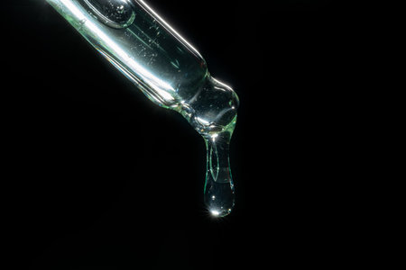liquid aqua serum lotion dropper of beauty cosmetic skincare, on black background