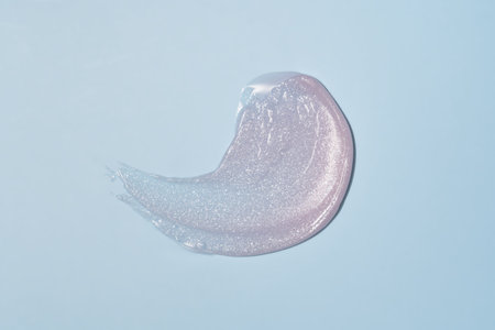 Cosmetic products jelly pink texture smudge on blue background. Skin care product presentation.の写真素材
