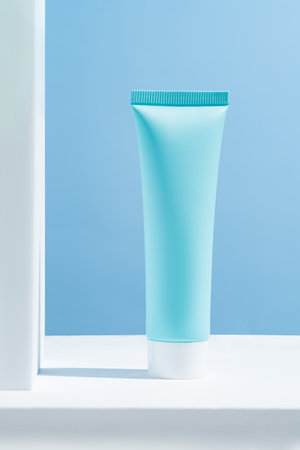 Cosmetics packaging. Blue plastic tube of cream on white podiums. Blank packaging. Natural beauty spa product concept. Beauty. Mock-up.の写真素材