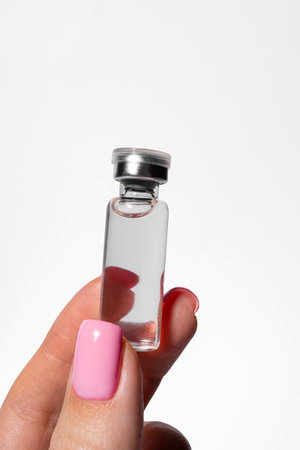 Esthetician hand gripping professional grade serum ampoule for facial treatment salon skincare serviceの写真素材