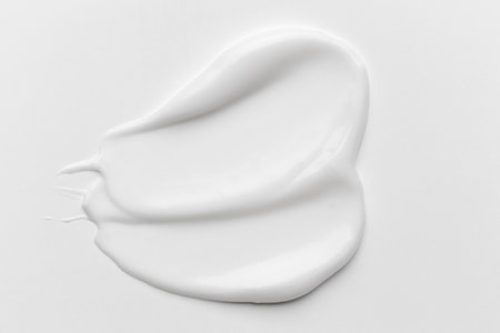 cosmetic smears cream texture on white background. Beauty serum drop. air and creamy skin care product sample.の写真素材