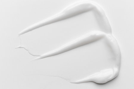 cream stroke isolated on white background. White cream smear smudge sample. face or body skincare product swatch. showcase of the productの写真素材