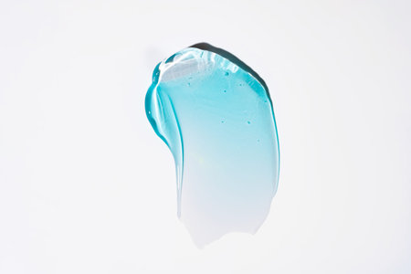 Pure blur transparent cosmetic gel smear on white background, skin care glycerin texture. top view