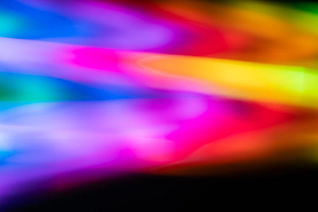 Bright neon light trails in pink, blue, and yellow creating a fast-paced abstract composition....