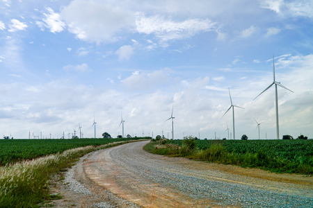 Wind turbines generating electricity with green meadow - Eco power